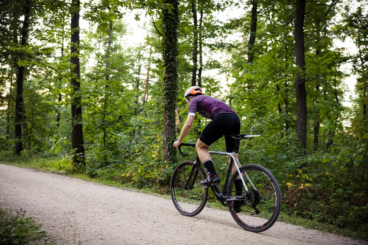 Gravel cyclists riding together on a mountain pass with guides leading them